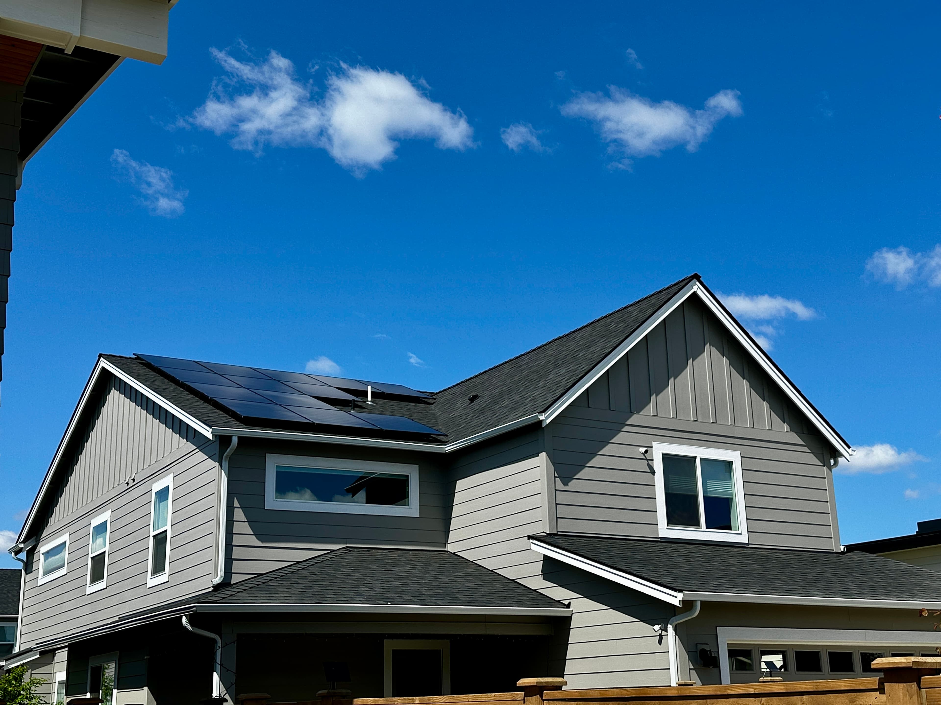 Rooftop solar panels on an Oregon home under a clear blue sky
